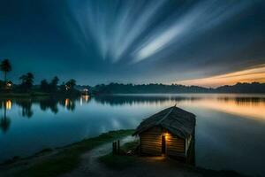 a small wooden hut sits on the shore of a lake at night. AI-Generated photo