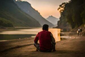 a man sitting on the side of a river at sunset. AI-Generated photo