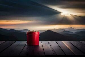 a red bucket on a wooden table in front of a mountain view. AI-Generated photo