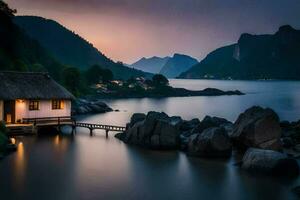 a small house sits on the shore of a lake at dusk. AI-Generated photo