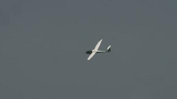 Glider is landing on a small airfield. Non motorized aircraft. Glider against blue sky video