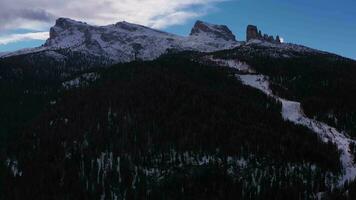 Cinque Torri, Forest and other Mountains in Winter. Dolomites, Italy. Aerial View. Drone Flies Sideways, Tilt Up video