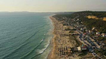 Fonte da Telha Beach and Atlantic Ocean. Portugal. Crowd of People. Aerial View. Drone Flies Forward and Upwards. Medium Shot video