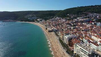 Sesimbra Town on Sunny Day. Sandy Beach and Atlantic Ocean. Green Hills. Portugal. Aerial View. Drone Flies Forward and Upwards video