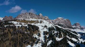 Pizes de Cir Mountain Range and Gardena Pass on Sunny Winter Day. South Tyrol, Dolomites, Italy. Aerial View . Drone Flies Upwards. Reveal Shot video