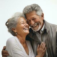 an older man and woman smiling and holding onto each other photo