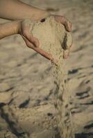 sand in hands photo