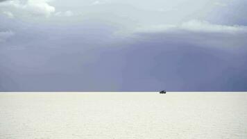 Uyuni Salt Flats on Cloudy Day and Car Passing By. Bolivia video