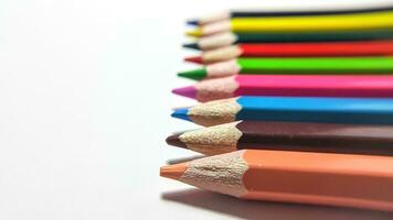 wooden color pencils arranged in bulk on a white isolated background photo