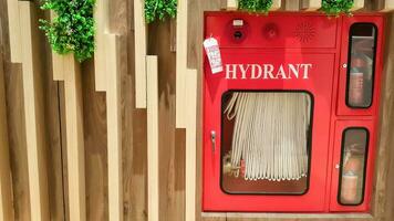 Hydrant with water hoses and fire extinguish equipment. Fire safety equipment in the red box at a shopping mall. photo