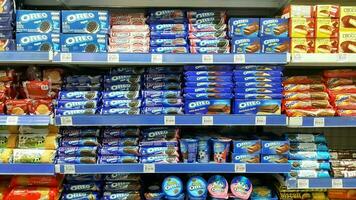 Various biscuits and wafers neatly arranged on shelves photo