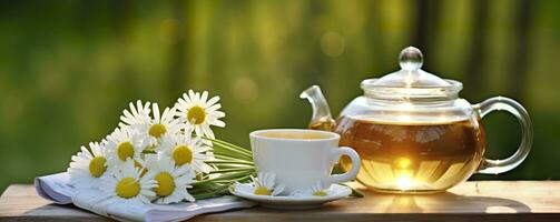 Chamomile flowers, books, a glass teapot, and a cup of herbal tea on a table closeup. Generative AI photo