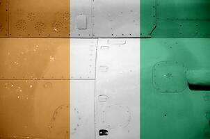 Ivory Coast flag depicted on side part of military armored helicopter closeup. Army forces aircraft conceptual background photo