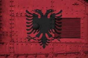 Albania flag depicted on side part of military armored tank closeup. Army forces conceptual background photo