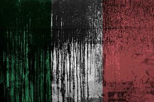 Italy flag depicted in paint colors on old and dirty oil barrel wall closeup. Textured banner on rough background photo