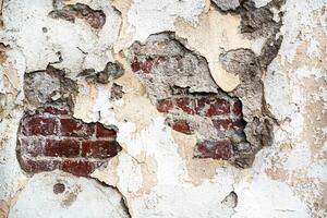 Old damaged brick wall and plaster, texture background. photo