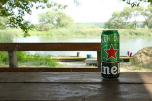 KHARKOV, UKRAINE - JULY 31, 2021 Green tin can of Heineken lager beer produced by the Dutch brewing company Heineken N.V. photo