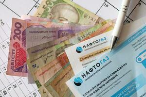 KYIV, UKRAINE - JULY 7, 2023 Naftogaz utility bill document with ukrainian hryvnias money photo