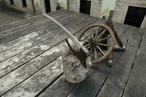 TERNOPIL, UKRAINE - AUGUST 23, 2023 Axe of executioner on wooden stump in the museum of tortures on territory of Zbarazh castle photo