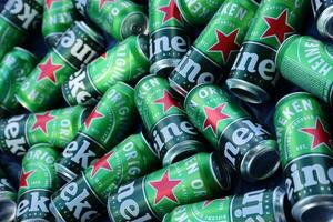 KHARKOV, UKRAINE - JULY 31, 2021 Green tin cans of Heineken lager beer produced by the Dutch brewing company Heineken N.V. photo