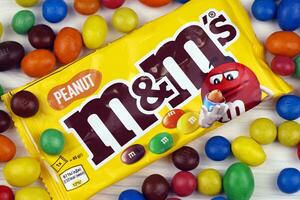 KHARKIV, UKRAINE - JANUARY 2, 2021 M and Ms colorful button shaped chocolate candies. Multi colored chocolates each of which has the letter m printed in lower case in white photo