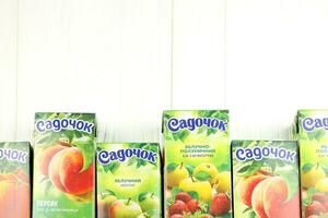 KHARKIV, UKRAINE - JANUARY 2, 2021 Sadochok various taste nectar from peach, apple and strawberry with orange flavour juice photo