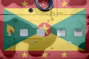 Grenada flag depicted on side part of military armored helicopter closeup. Army forces aircraft conceptual background photo