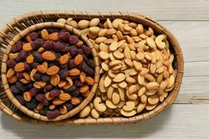 Dried fruits and nuts mixed in a bowl. background. AI Generative Pro Photo