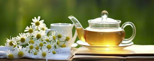 Chamomile flowers, books, a glass teapot, and a cup of herbal tea on a table closeup. Generative AI photo