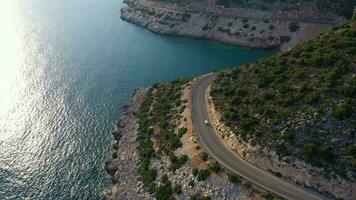 Car on Road along Coastline. Sea and Hills. Aerial View. Turkey. Drone Flies Forward video