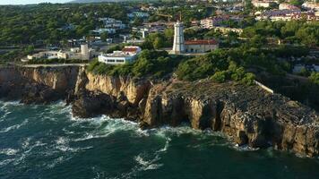 CASCAIS, PORTUGAL - AUGUST 16, 2022 Cliffs, Guia Lighthouse and Atlantic Ocean. Portugal. Aerial View. Orbiting video