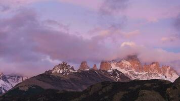 Mount Fitz Roy in Clouds at Sunrise. Hills and Snow-Capped Mountains. Andes, Patagonia, Argentina. Time Lapse video