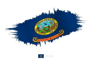 pintado pincelada bandera de Idaho con ondulación efecto. vector