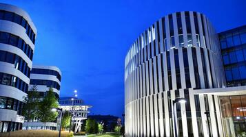 Pattern of office buildings windows illuminated at night. Glass architecture ,corporate building at night - business concept. photo