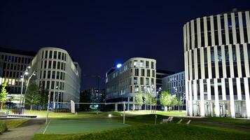 Pattern of office buildings windows illuminated at night. Glass architecture ,corporate building at night - business concept. photo