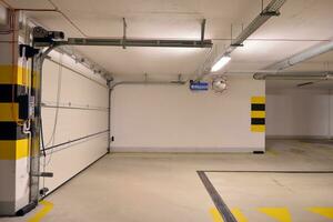 típico subterráneo coche estacionamiento garaje en un moderno Departamento casa. interior pilares pintado amarillo. foto