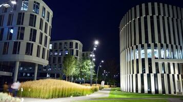 Pattern of office buildings windows illuminated at night. Glass architecture ,corporate building at night - business concept. photo