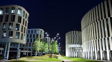 Pattern of office buildings windows illuminated at night. Glass architecture ,corporate building at night - business concept. photo