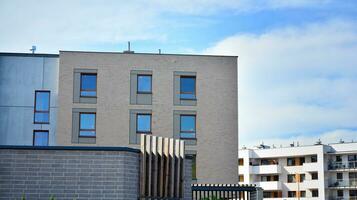 Modern apartment buildings on a sunny day with a blue sky. Facade of a modern apartment building. Glass surface with sunlight. photo