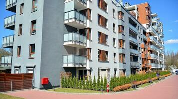 Modern apartment buildings on a sunny day with a blue sky. Facade of a modern apartment building. Glass surface with sunlight. photo