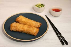 Fried springrolls on a white table. photo