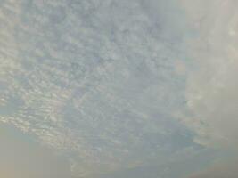 Nature background. Sky, sun and clouds with rays of light at sunset on the island of Lombok, Indonesia. photo