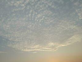 Nature background. Sky, sun and clouds with rays of light at sunset on the island of Lombok, Indonesia. photo