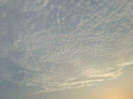 Nature background. Sky, sun and clouds with rays of light at sunset on the island of Lombok, Indonesia. photo