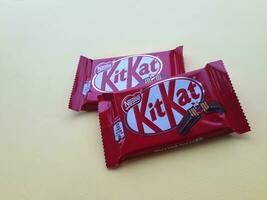 KHARKIV, UKRAINE - JANUARY 2, 2021 Kit Kat by Nestle chocolate covered wafer on bright color photo