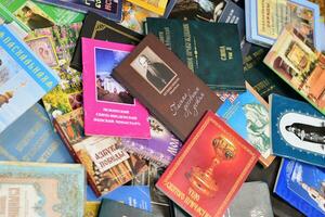 KYIV, UKRAINE - 4 MAY, 2023 Christian slavonic religious book stacked on table in chaotic order photo