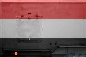 Yemen flag depicted on side part of military armored truck closeup. Army forces conceptual background photo