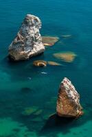 Two Kayaks on the background of coastal cliffs, calm clear blue sea, rock Orest and Pilad, cape Fiolent in Balaklava Sevastopol Crimea. The concept of an active and healthy life in harmony with nature photo