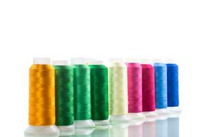 set of different color sewing threads,on white background. photo