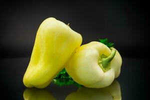 raw ripe green sweet pepper on black background. photo